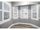 Living room featuring plantation shutters, wood floors, and paneled walls for a bright and airy feel at 299 Lake Arrowhead Rd., Myrtle Beach, SC 29572