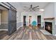 Bright, open living room with wood floors, a fireplace, and sliding barn door to a bedroom at 299 Lake Arrowhead Rd., Myrtle Beach, SC 29572