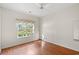 Cozy bedroom with wood flooring and a large window providing ample natural light and street views at 2995 Woodberry Ct., Little River, SC 29566