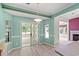 Dining area with sliding glass doors to sunroom, complemented by charming light fixture and wall trim at 2995 Woodberry Ct., Little River, SC 29566