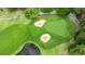 Overhead shot of golf course with sand traps and manicured green, perfect for avid golfers at 2995 Woodberry Ct., Little River, SC 29566