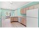 Well-lit kitchen with light wood cabinets, white appliances, and a cozy breakfast nook at 2995 Woodberry Ct., Little River, SC 29566