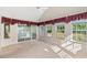Bright sunroom with large windows and sliding glass doors overlooking the backyard at 2995 Woodberry Ct., Little River, SC 29566