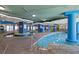 Spacious indoor pool area with a lazy river, multiple entrances, and brick flooring at 304 North Ocean Blvd. # 506, North Myrtle Beach, SC 29582