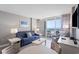 Comfortable living room featuring a blue sofa, beach-themed artwork, and balcony access at 304 North Ocean Blvd. # 506, North Myrtle Beach, SC 29582