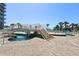 Beautifully landscaped pool bridge connecting different sections of the pool with lounge seating nearby at 304 North Ocean Blvd. # 506, North Myrtle Beach, SC 29582