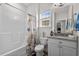 Well-lit bathroom featuring a shower, seashell-themed curtain and a vanity with modern fixtures at 322 Canyon Dr., Conway, SC 29526