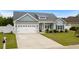 Charming two-story home with a large driveway, well-maintained lawn, and inviting curb appeal at 322 Canyon Dr., Conway, SC 29526