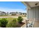 Charming front porch view with rocking chair seating and well-maintained landscaping at 322 Canyon Dr., Conway, SC 29526