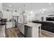 Bright kitchen featuring an island with seating, stainless steel appliances, and a view into the living area at 322 Canyon Dr., Conway, SC 29526