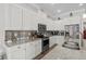 Updated kitchen features granite countertops, stainless steel appliances, and white cabinetry at 322 Canyon Dr., Conway, SC 29526