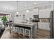 Modern kitchen with white cabinets, a large granite island, and stainless steel appliances at 322 Canyon Dr., Conway, SC 29526