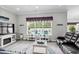 Light and bright living room featuring a view of the pool and a gray leather couch at 322 Canyon Dr., Conway, SC 29526