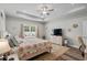 Main bedroom features a ceiling fan, tray ceiling, a large window, and neutral decor at 322 Canyon Dr., Conway, SC 29526