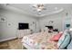 Relaxing bedroom showcasing a ceiling fan, tray ceiling, a dresser, and coastal decor at 322 Canyon Dr., Conway, SC 29526