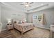 Comfortable main bedroom with a tray ceiling, ceiling fan, and a large window at 322 Canyon Dr., Conway, SC 29526