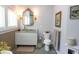 Stylish bathroom with vessel sink, ornate mirror, toilet, and woven accent wall at 329 Kauffman St., Georgetown, SC 29440