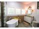 Bright bathroom features soaking tub, glass bowl sink, and decorative wall details at 329 Kaufman St., Georgetown, SC 29440