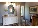 Bathroom features a marble vanity, decorative mirror, and patterned tile floors at 329 Kauffman St., Georgetown, SC 29440
