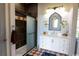 Updated bathroom boasts a glass shower, marble vanity, and decorative mirror at 329 Kauffman St., Georgetown, SC 29440
