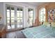 Bedroom featuring french doors, an arched window and light-filled natural wood details at 329 Kaufman St., Georgetown, SC 29440