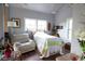 Bright bedroom featuring hardwood floors, comfortable seating, and cheerful patterned bedding at 329 Kauffman St., Georgetown, SC 29440