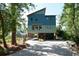 Unique coastal home on stilts with gravel driveway and lush landscaping at 329 Kauffman St., Georgetown, SC 29440