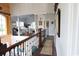 Bright hallway with railing overlooking the lower level, with a view of the primary bedroom at 329 Kauffman St., Georgetown, SC 29440