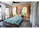 Bright main bedroom with wood paneling, windows, and outdoor access at 329 Kauffman St., Georgetown, SC 29440