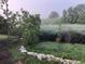 Picturesque marsh view featuring lush greenery, trees and serene waters, under a light fog at 329 Kaufman St., Georgetown, SC 29440