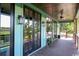 Charming porch with outdoor lighting, ceiling fan, and a scenic view, framed by black grid windows at 329 Kaufman St., Georgetown, SC 29440