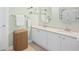 Bathroom featuring double sinks, white cabinets, and a woven storage basket at 4 Stillwater Ct., Murrells Inlet, SC 29576