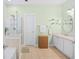 Bright bathroom featuring a glass shower, neutral tile, and ample storage with a white vanity at 4 Stillwater Ct., Murrells Inlet, SC 29576