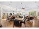 Large community room with tables, chairs, hardwood floors and an abundance of natural light at 4 Stillwater Ct., Murrells Inlet, SC 29576