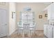 A cozy dining area featuring a round table, white chairs, and natural lighting at 4 Stillwater Ct., Murrells Inlet, SC 29576