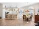 Open-concept dining room and kitchen area with hardwood floors, an eat-in bar, and plenty of natural light at 4 Stillwater Ct., Murrells Inlet, SC 29576
