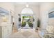 Bright foyer with tiled flooring, arched doorway and views through the front door to exterior landscaping at 4 Stillwater Ct., Murrells Inlet, SC 29576