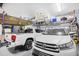 Organized two-car garage with storage racks, a truck, and a SUV at 4 Stillwater Ct., Murrells Inlet, SC 29576