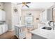 Bright kitchen with white cabinets, stainless sink, an island, and a casual dining area at 4 Stillwater Ct., Murrells Inlet, SC 29576