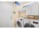 Functional laundry room with modern washer and dryer, overhead cabinets, and storage space at 4 Stillwater Ct., Murrells Inlet, SC 29576