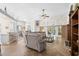 Spacious living room with hardwood floors, a ceiling fan, and sliding glass doors leading to the patio at 4 Stillwater Ct., Murrells Inlet, SC 29576