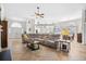 Open-concept living room showcasing hardwood floors, a comfortable sectional sofa, and a cozy atmosphere at 4 Stillwater Ct., Murrells Inlet, SC 29576