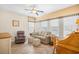Comfortable living room featuring a sofa, recliner, and a classic wood desk under natural light at 4 Stillwater Ct., Murrells Inlet, SC 29576