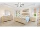 Spacious primary bedroom featuring a tray ceiling, ceiling fan, and neutral decor at 4 Stillwater Ct., Murrells Inlet, SC 29576