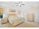 Bright primary bedroom with tray ceiling, fan, beach-themed decor and an ensuite bath at 4 Stillwater Ct., Murrells Inlet, SC 29576
