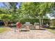 Brick patio with an outdoor kitchen featuring a barbecue grill and lush landscaping at 4 Stillwater Ct., Murrells Inlet, SC 29576