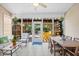 Relaxing screened-in patio showcasing dining table and view to outdoor area with yellow furniture at 4 Stillwater Ct., Murrells Inlet, SC 29576