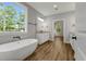 Bright bathroom featuring a freestanding tub, double vanity, and natural light from the window at 4120 Whatuthink Rd., Myrtle Beach, SC 29588