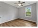 This lovely bedroom features natural light, light grey walls and wood-look flooring at 4120 Whatuthink Rd., Myrtle Beach, SC 29588