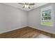 This lovely bedroom features natural light, light grey walls and wood-look flooring at 4120 Whatuthink Rd., Myrtle Beach, SC 29588